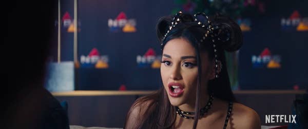 Ariana with mouth wide open in surprise rocking pigtails