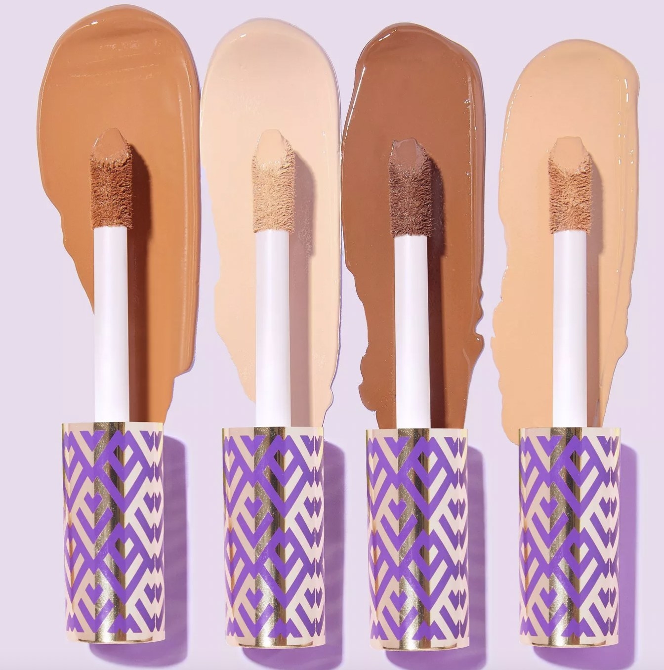A set of four concealer wands with different shades