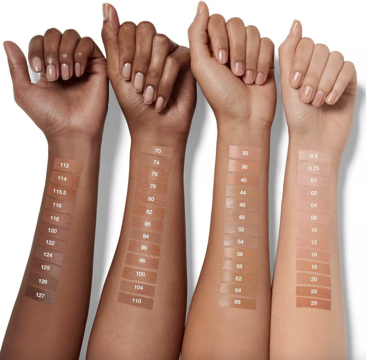 A set of four arms with foundation swatches