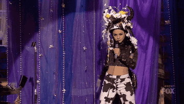 Vanessa Hudgens performs in a cow costume on Rent: Live.