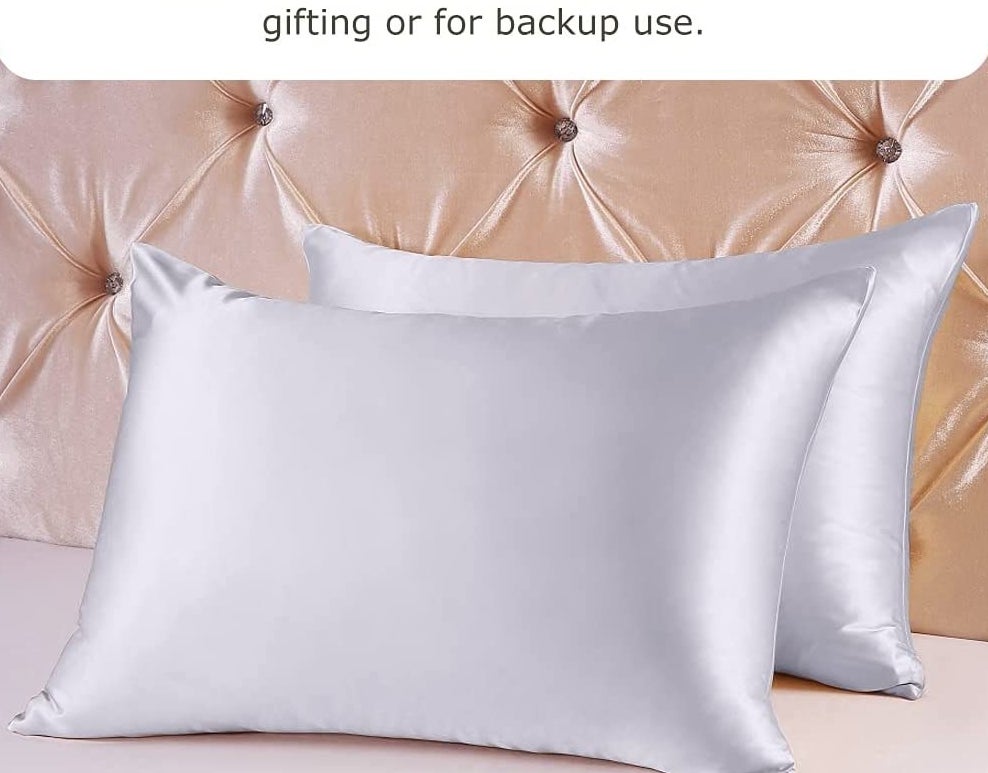 Two pillows covered in silk pillowcases