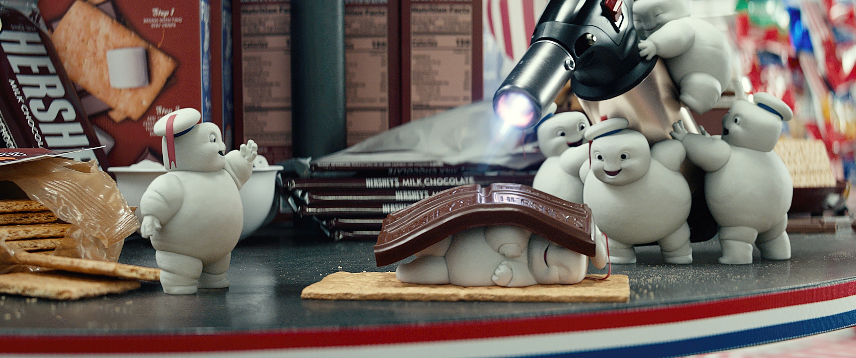 Tiny Stay Puft marshmallow men, making smores out of their own bodies