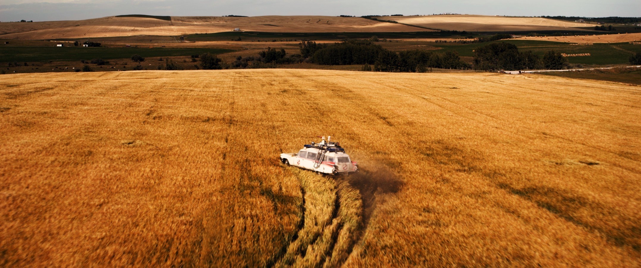 Ecto-1 driving through a field of grass in the middle of nowhere