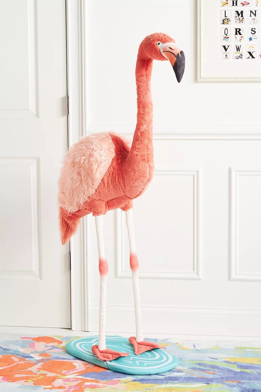 free standing flamingo doll in a bedroom