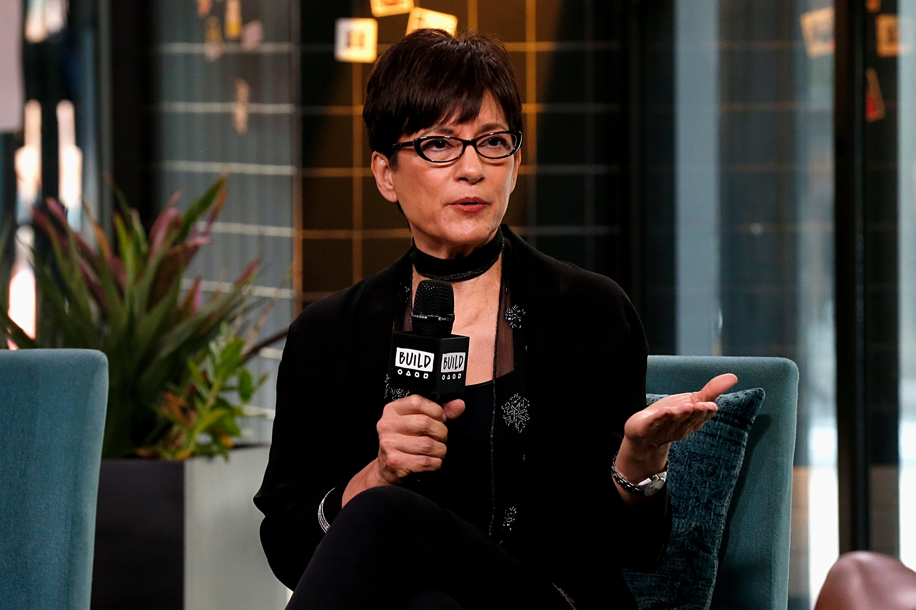 Photo of Ada Maris sitting in a chair with a microphone