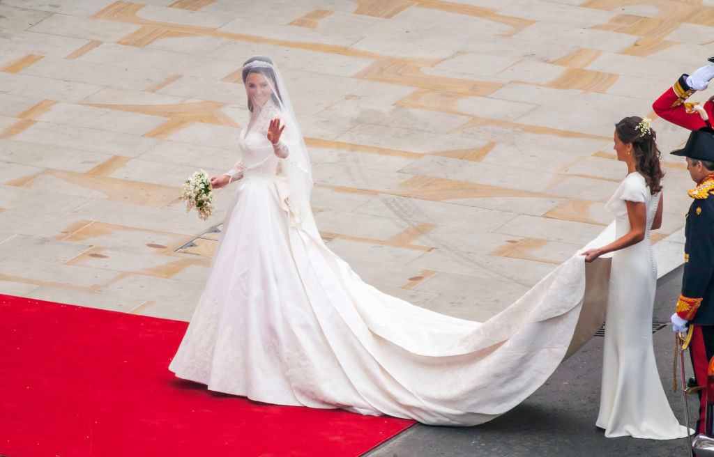 Kate Middleton arriving to her wedding in her dress with a long cape