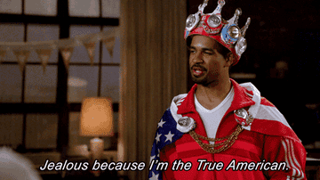 Man wearing a red, white, and blue crown and saying &quot;Jealous because I&#x27;m the True American&quot;