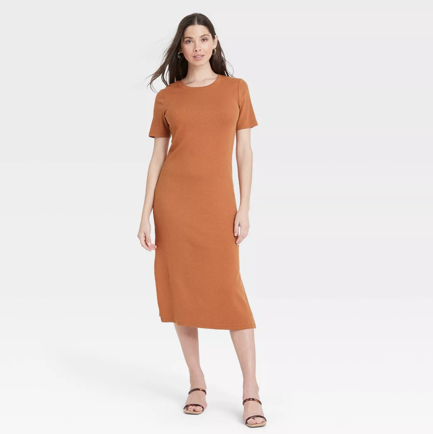 model wearing the dress in orange with sandals