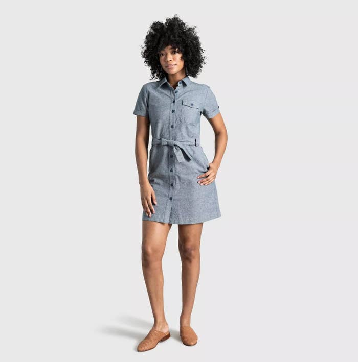 model wearing the blue tied button down dress with brown slides