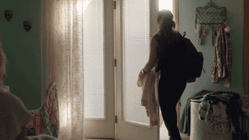 A woman leaving her home and shutting the door behind her