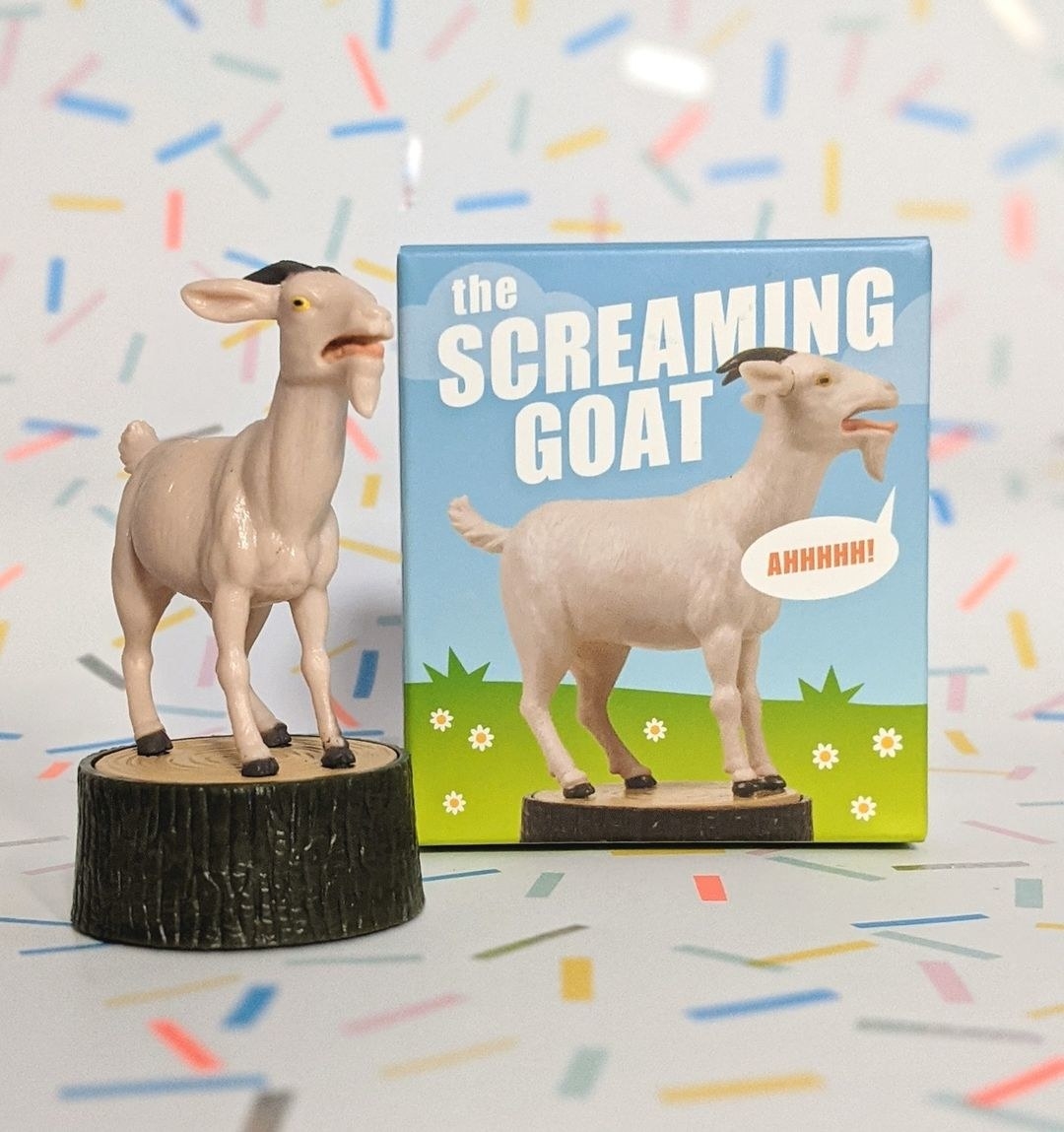 The goat figurine next to its box