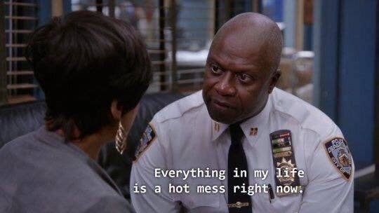 Andre Braugher dressed up in a Captain&#x27;s uniform, in the middle of a conversation with a lady, for his role as Captain Raymond Holt for Brooklyn Nine-Nine