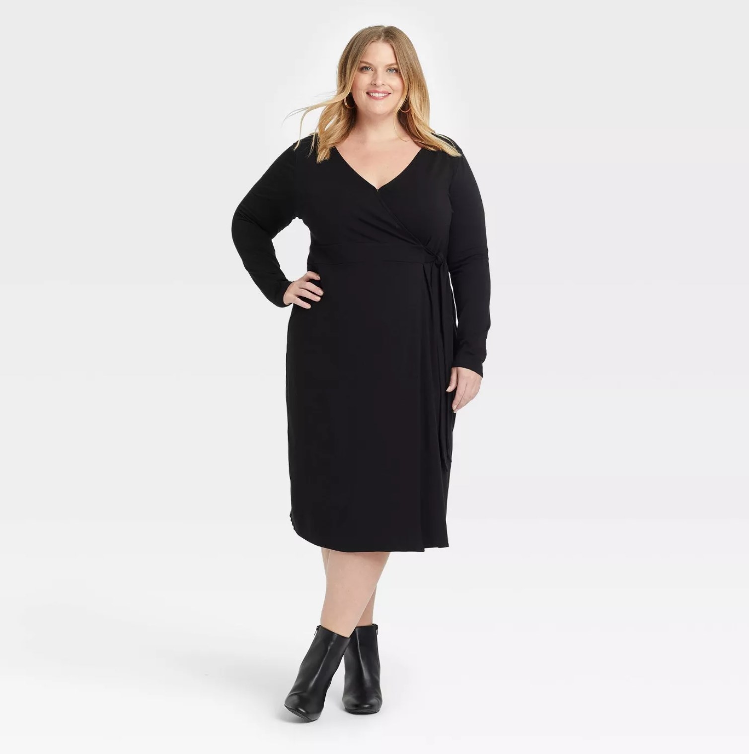 model wearing the wrap dress in black with black booties