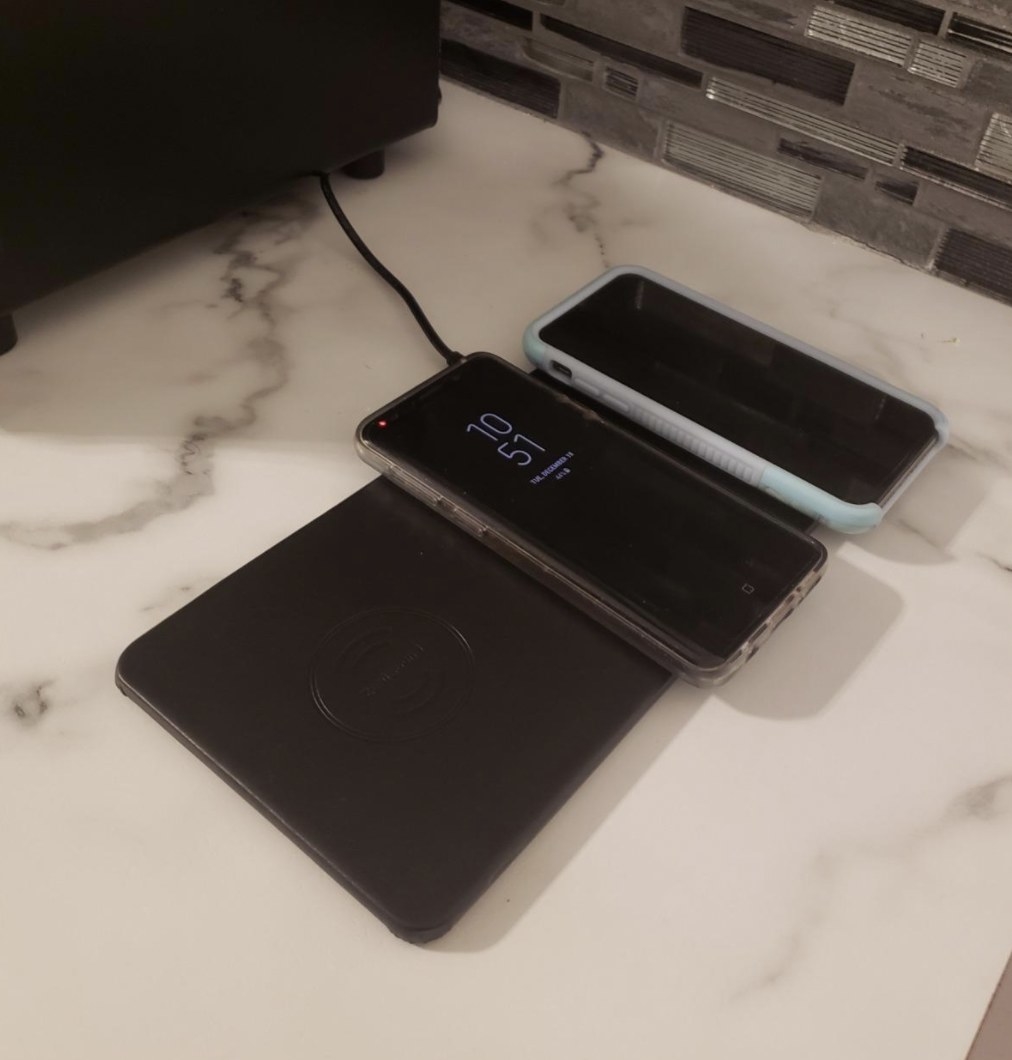 the charging pad in black charging two smartphones
