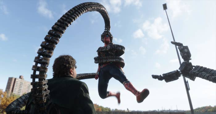 Doc Ock holding onto Spider-Man with his tentacles
