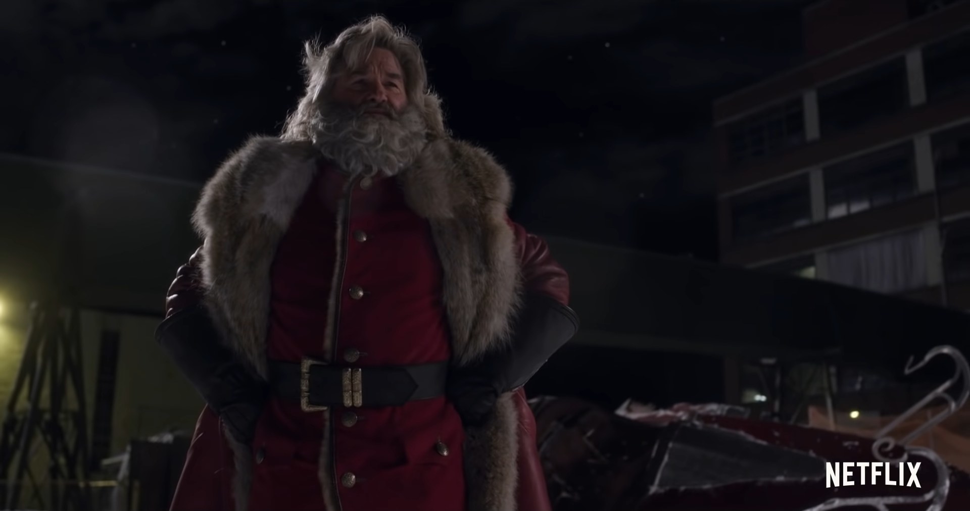 A man dressed as Santa Claus stands.