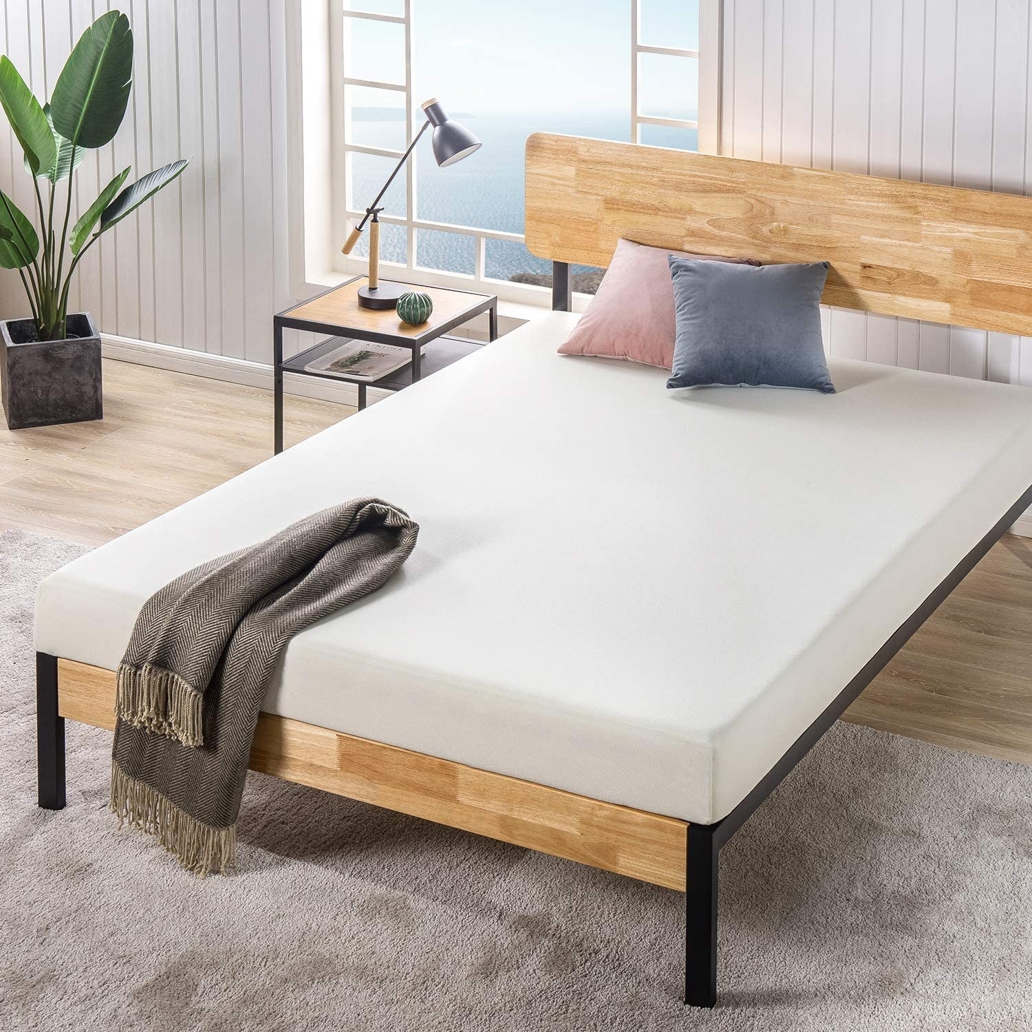 The mattress on a bed frame in a bedroom