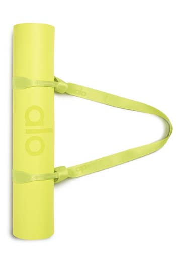 the bright yellow strap around bright yellow yoga mat