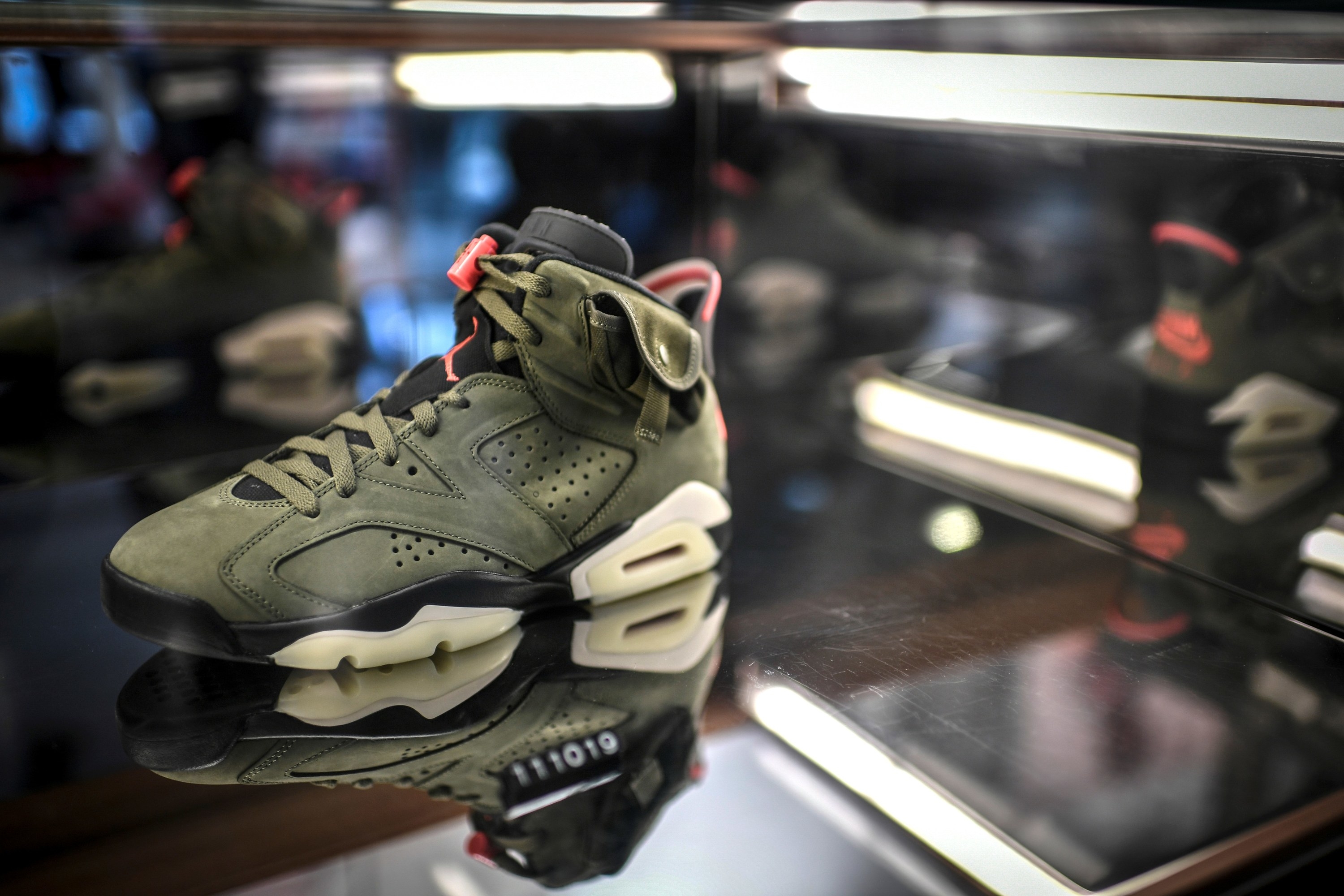 A limited-edition Travis Scott x Air Jordan 6 sneaker is displayed in a shop as part of the &quot;raffles&quot; on October 8, 2019, in Paris