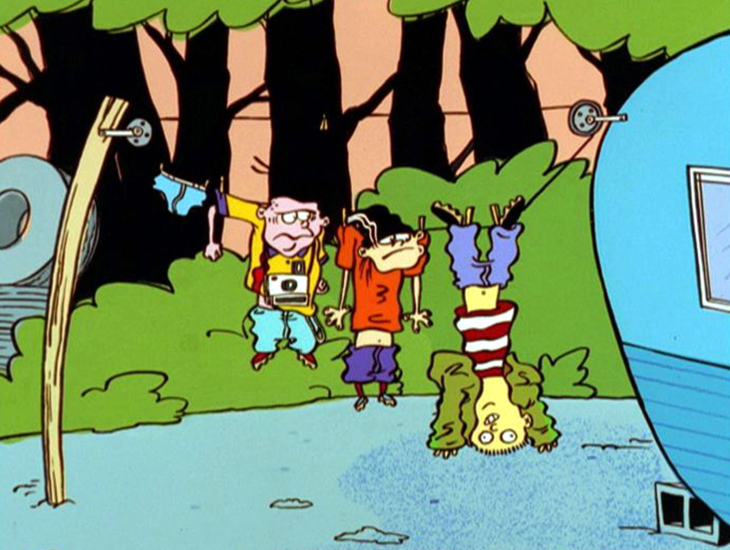 Ed, Edd and Eddy hang from a clothesline outside of a trailer, Ed hangs upside down by his feet while Double D and Eddy are pinned by their sleeves