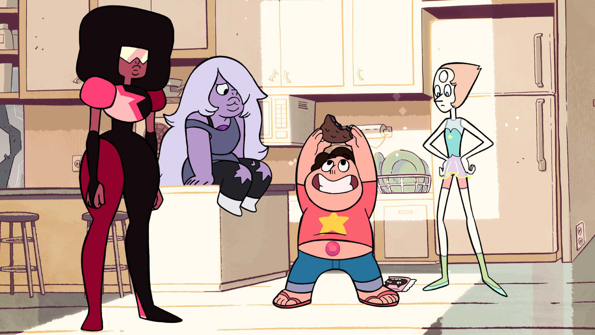 Steven Universe stands in kitchen with his bellybutton exposed, holding a snack cake up, joined by Crystal Gem beings Garnet, standing, Amethyst, seated on counter, and Pearl, watching from behind.