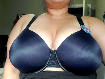 Reviewer photo of them wearing the bra in navy blue