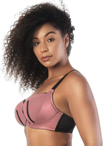 Side of model wearing pink and black balconette bra