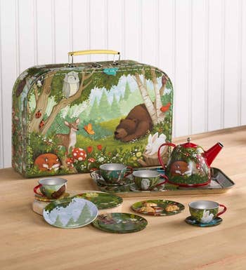 forest themed tin set with storage case, tray, teapot, and several cups and dishes
