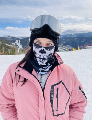 reviewer wearing pink jacket skiing