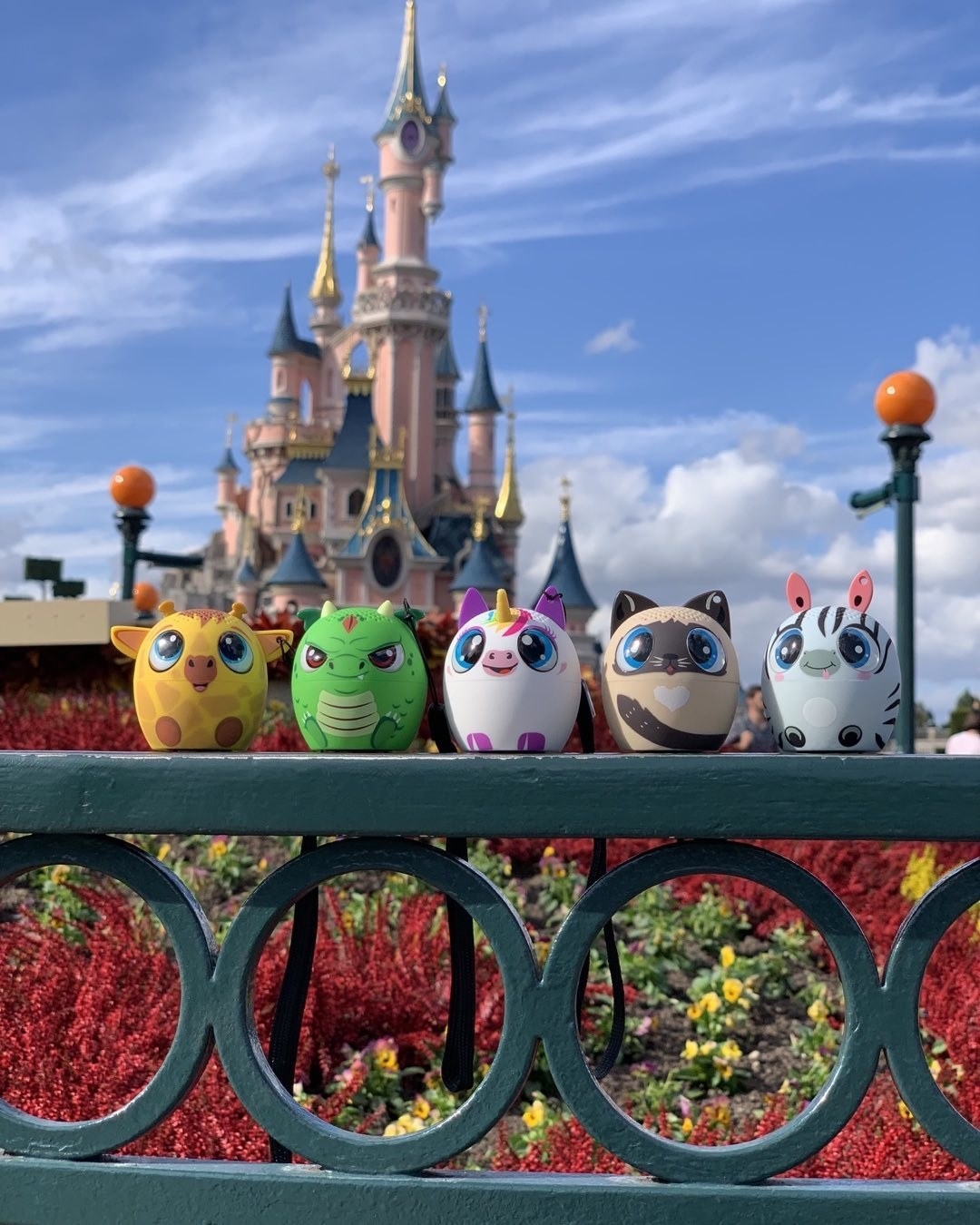 Several speakers lined up in front of a Disney castle