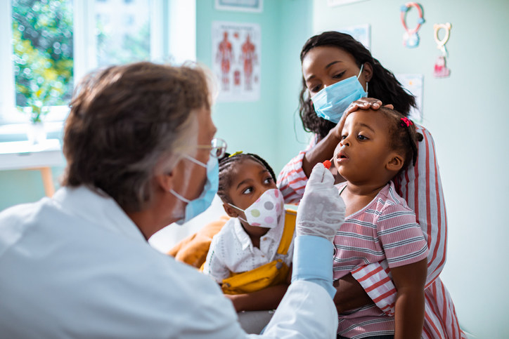 A doctor checking a toddler&#x27;s nostrils