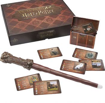 Complete packaging of Harry Potter game with wand, cards, and storage chest