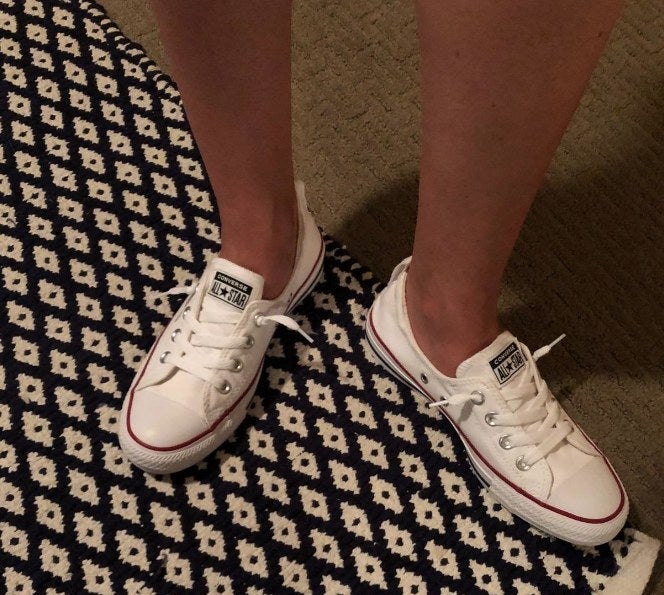 reviewer wearing the white converse sneakers