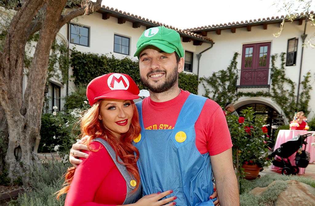 The couple is dressed up as Mario and Luigi