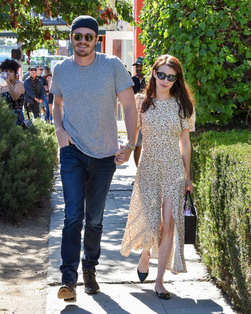Garrett Hedlund and Emma Roberts walk down the street hand in hand on Aug. 10, 2019, in Los Angeles