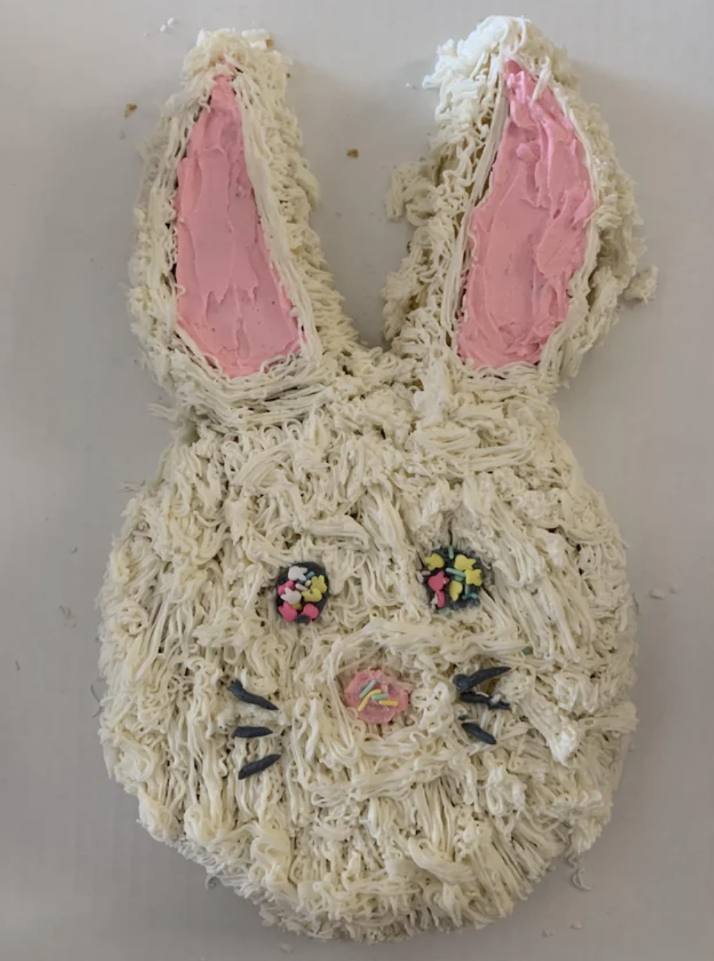 Rabbit face that looks very stringy and has pink gloopy ears