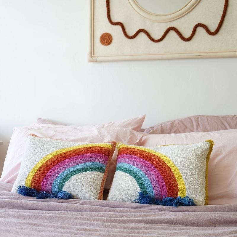 two pillows with two halves of a rainbow