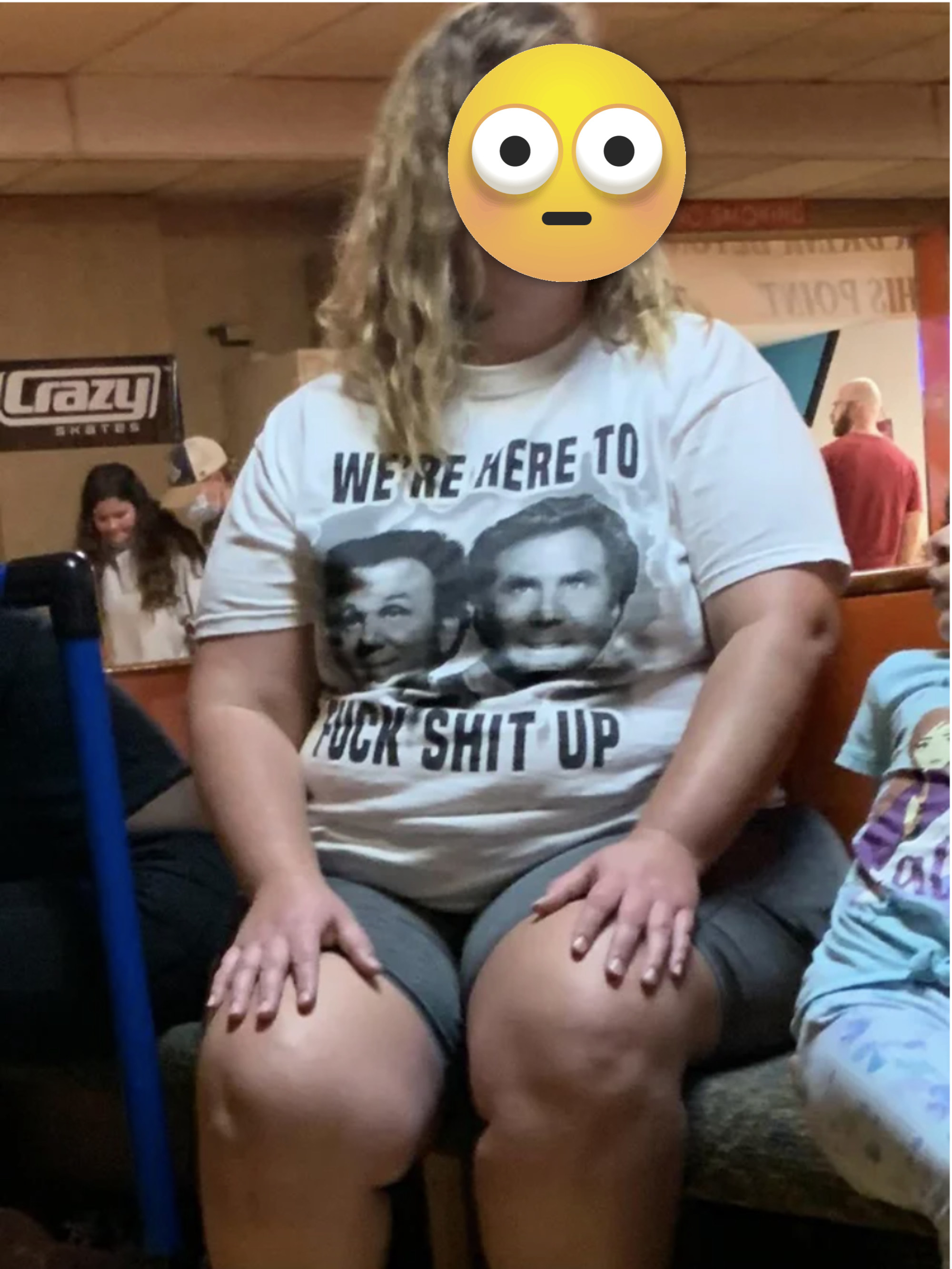 A woman wears a &quot;We&#x27;re here to fuck shit up&quot; T-shirt
