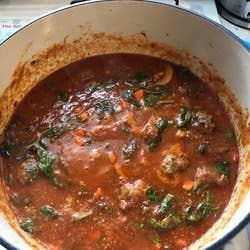 Reviewer photo of meatballs and tomato sauce being cooked in the Dutch oven