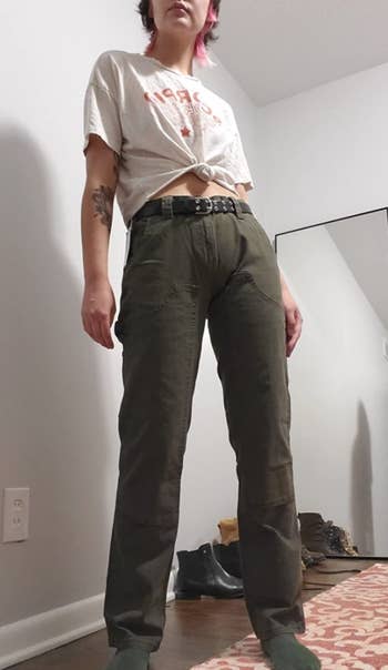a reviewer wearing the carpenter pants in green
