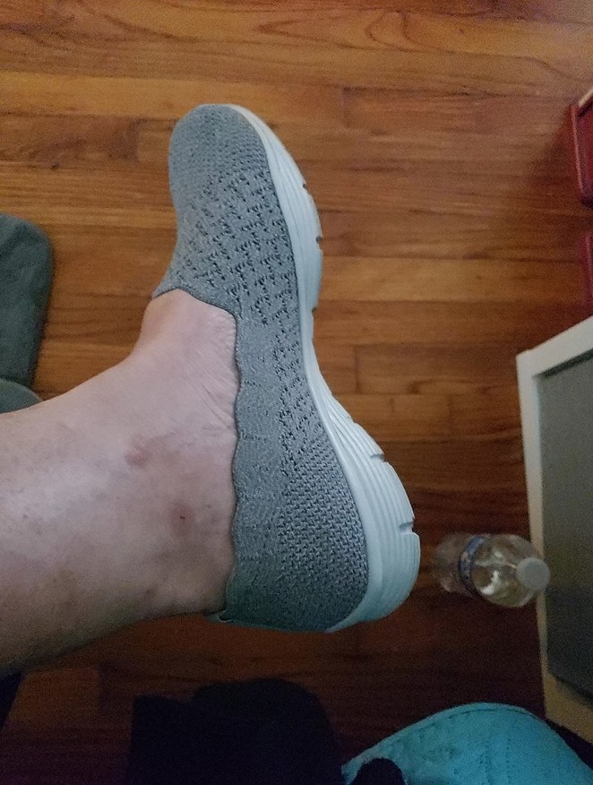 Reviewer wearing gray flat with white sole