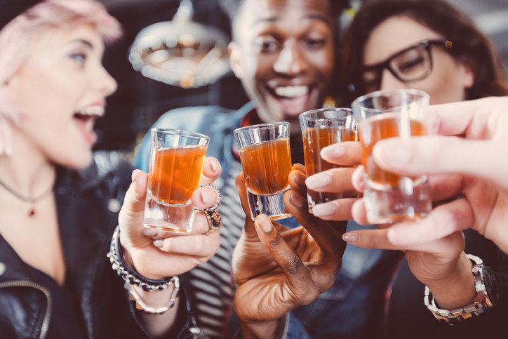 Friends drinking beer at a bar.