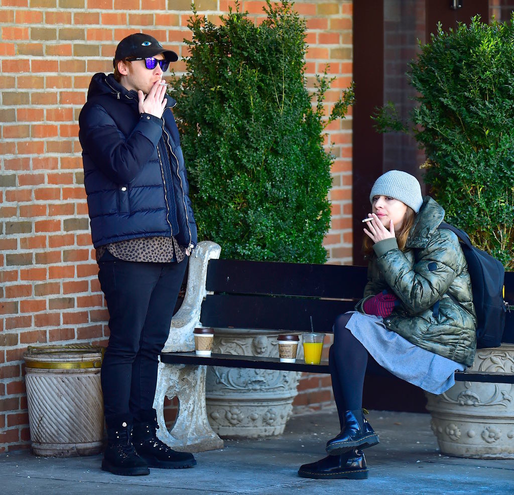 Rupert Grint, and Georgia Groome are seen in Soho smoking cigs