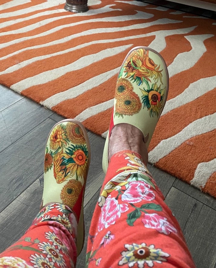 Reviewer wearing yellow sunflower print loafers