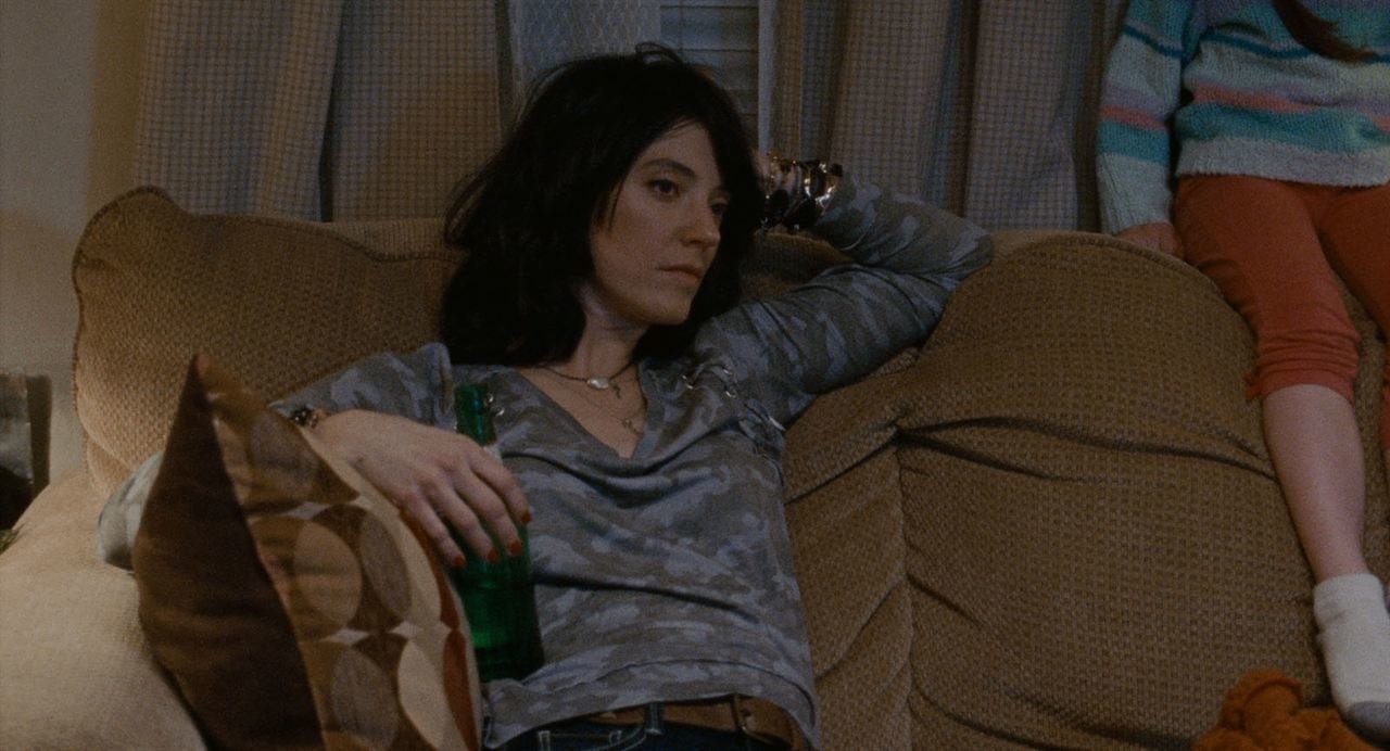 Sharon Van Etten sits on the couch with a beer in her hand