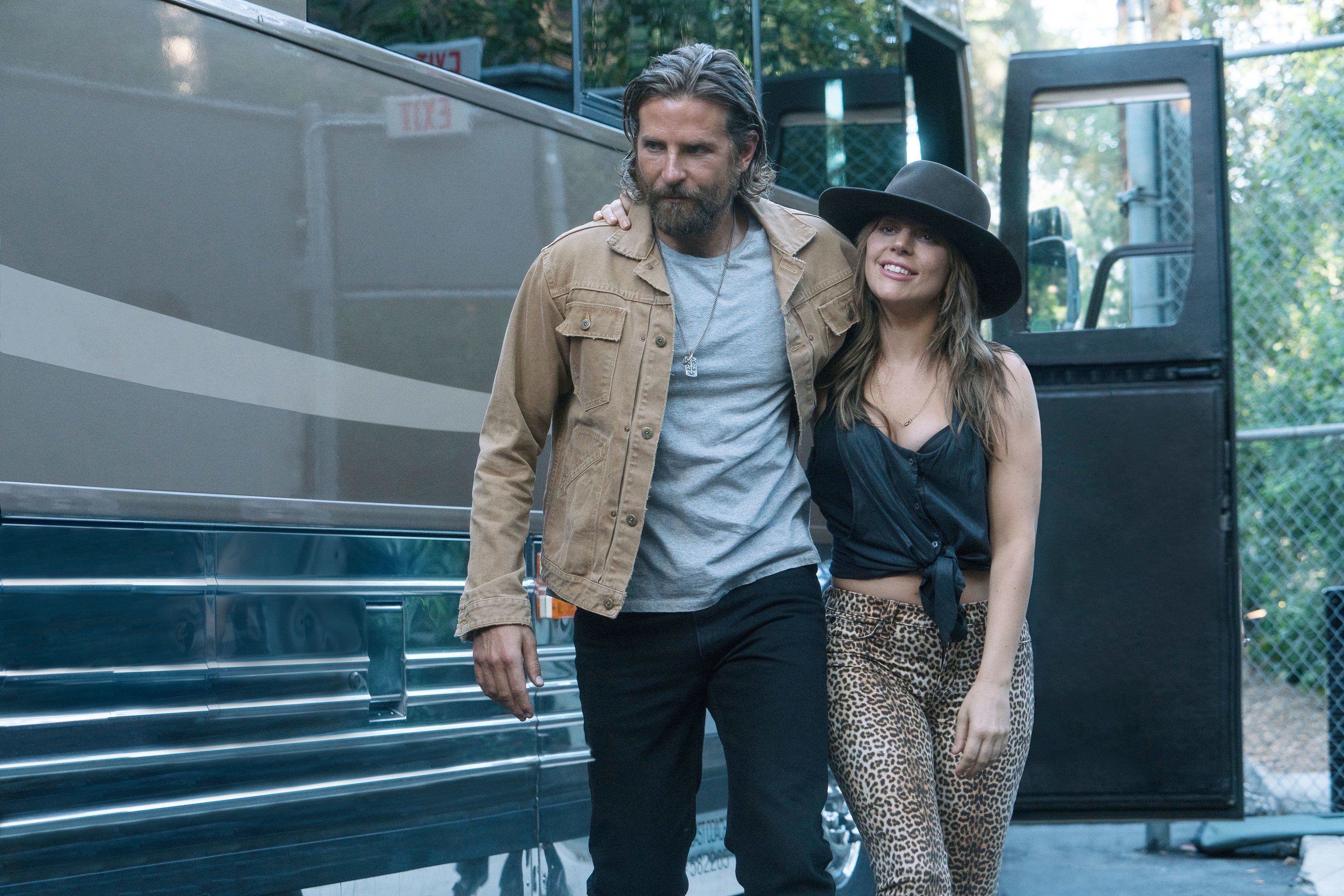 Bradley Cooper and Lady Gaga get off of a tour bus