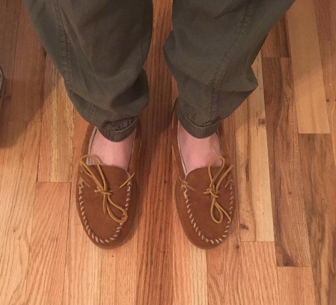 reviewer wearing the brown suede flats
