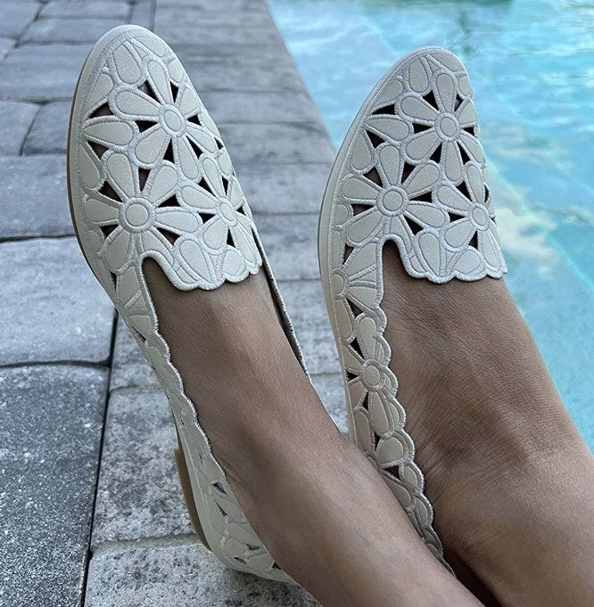 Reviewer wearing white floral cut-out flats