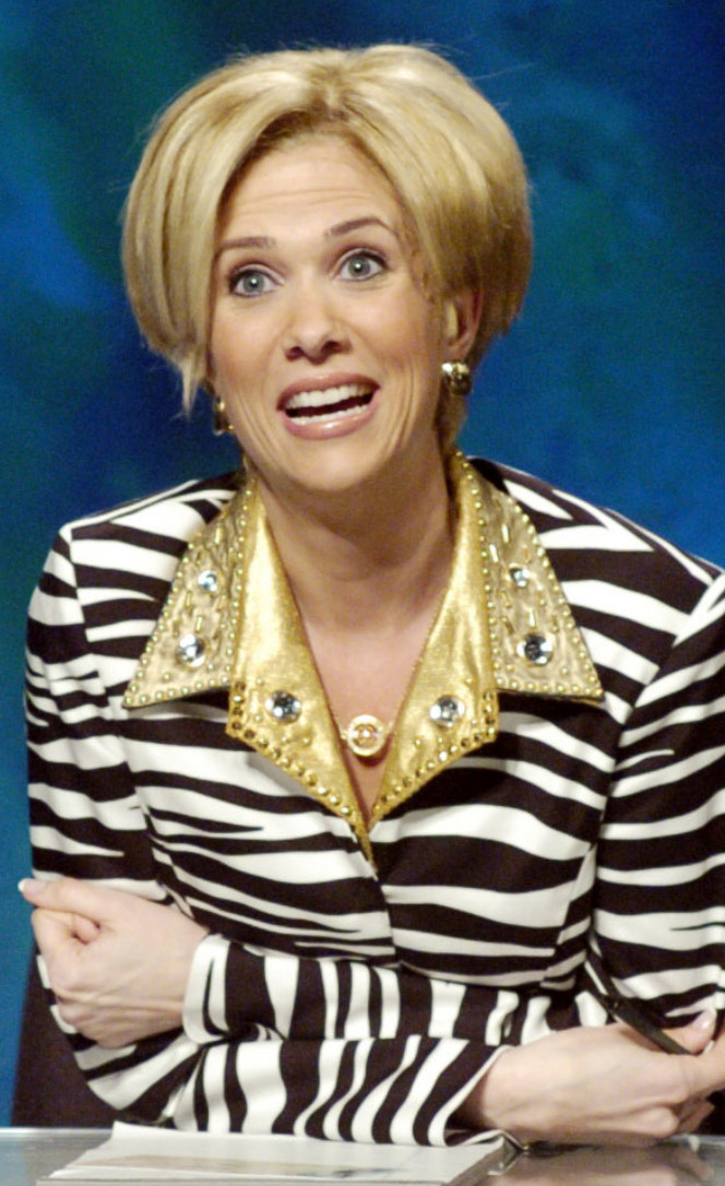 Wiig wearing a short wig, zebra patterned suit with gold collar