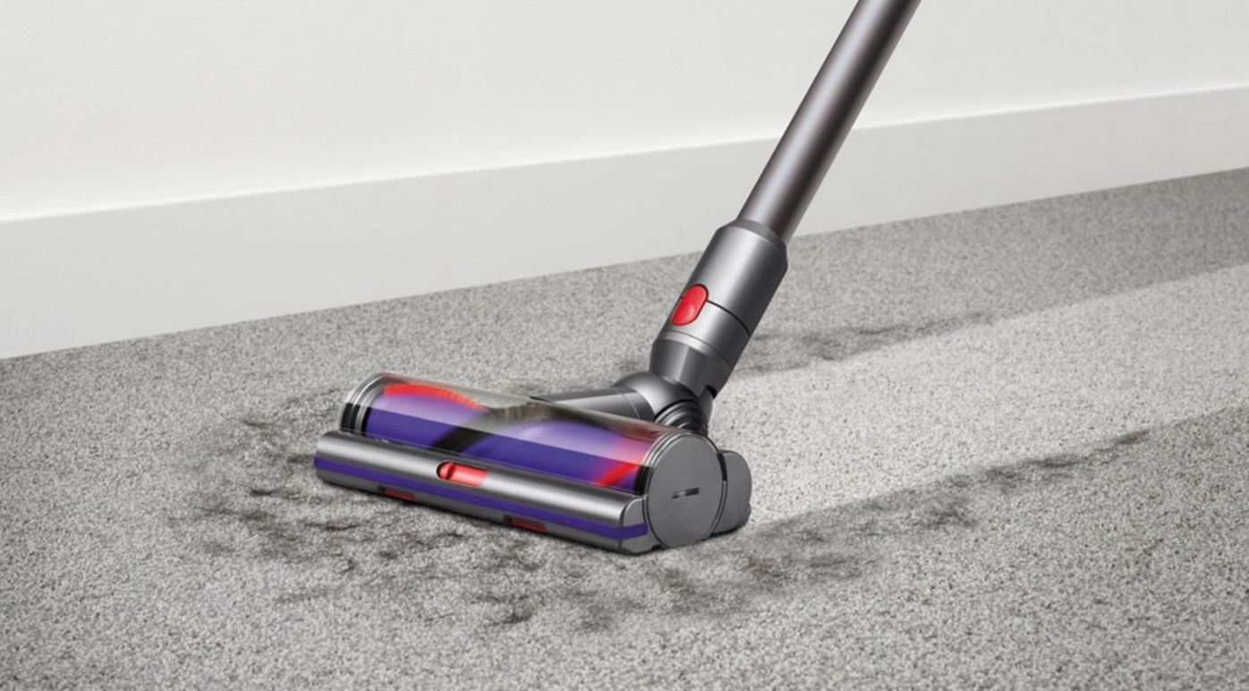A cordless vacuum picking up animal fur off the floor